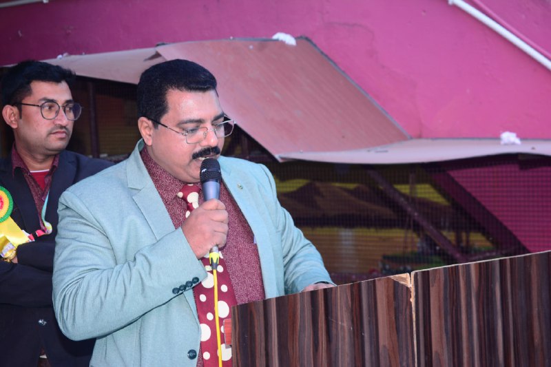 A young student raising his hand in a classroom